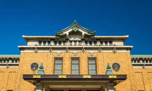 Low angle view of building against clear blue sky