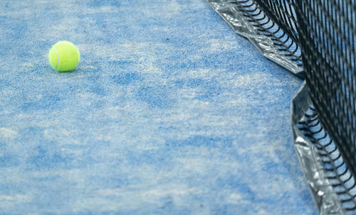 High angle view of tennis ball lying at courtyard