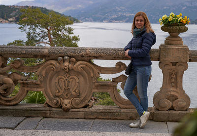 Rear view of woman standing by fountain