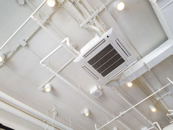 Low angle view of illuminated pendant light in building