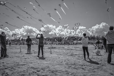 Group of people flying against sky