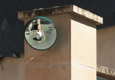 Reflection of woman photographing on mirror