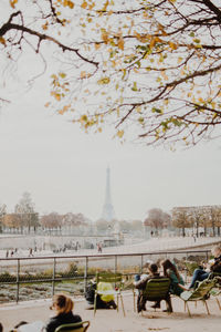 People in town square with city in background