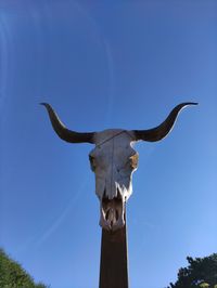 Low angle view of statue against clear blue sky