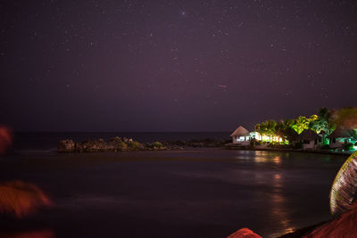 Scenic view of sea against sky at night