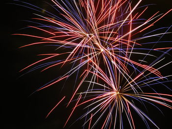 Low angle view of firework display at night