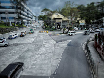 Cars on road against sky in city