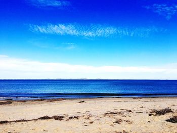 Scenic view of sea against blue sky