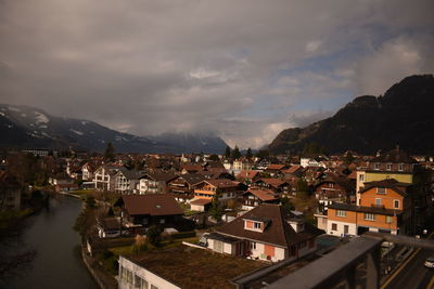 High angle view of townscape and mountains against sky