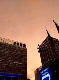 Low angle view of modern buildings against sky during sunset