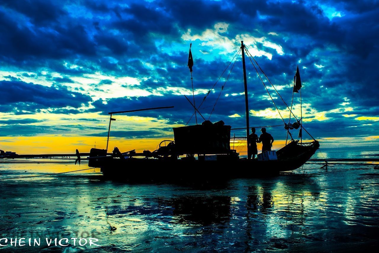 SILHOUETTE SAILBOATS IN SEA AGAINST DRAMATIC SKY