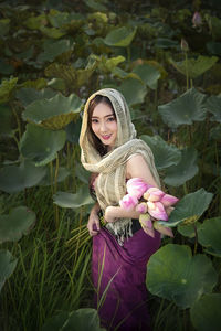 Portrait of woman with pink flower