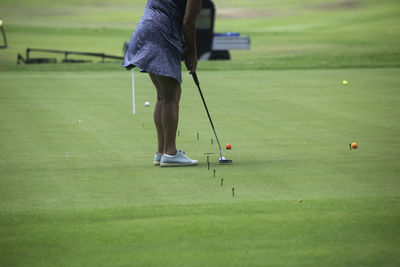 A rearview shot of an active elderly woman playing golf and enjoying outdoor recreation in mexico