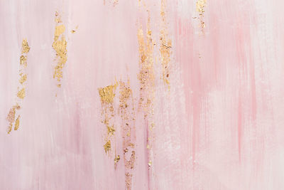 Delicate pink marble background with gold brushstrokes. place for your design.