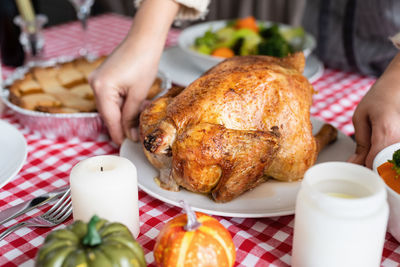 Cropped hand of woman holding food