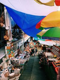 Multi colored umbrellas at market stall in city