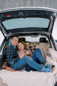 High angle view of woman sitting in car