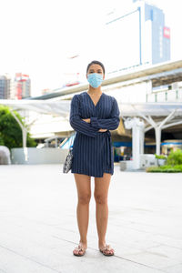 Full length of woman standing on city street