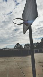 View of basketball hoop against cloudy sky