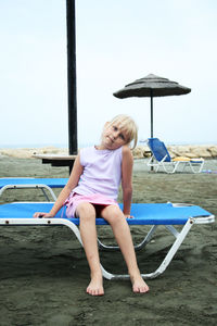 Rear view of woman sitting in swimming pool