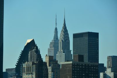 Low angle view of modern building against blue sky