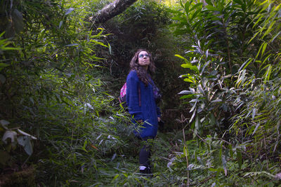 Portrait of woman standing in forest