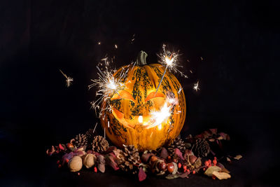 Close-up of illuminated pumpkin against black background