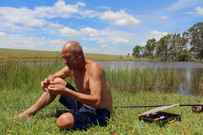 Fisherman preparing his fishing equipment at a lake 