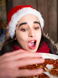 Close-up of shocked woman with food in plate