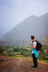 Rear view of man looking at mountains