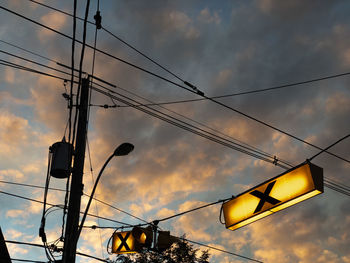 Low angle view of illuminated street light against sky