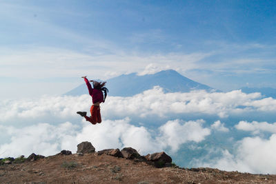 Low angle view of person paragliding against sky