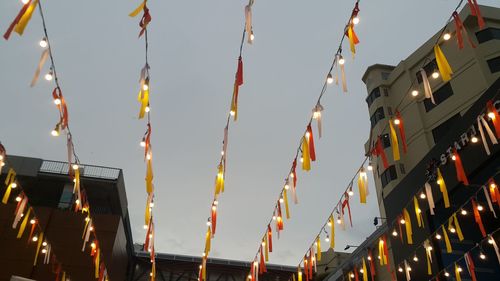 Low angle view of illuminated lights against sky at night