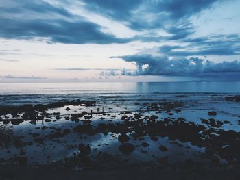 Scenic view of sea against cloudy sky