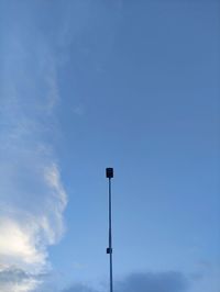 Low angle view of street light against blue sky