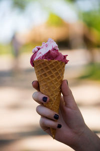 Cropped hand of woman holding ice cream cone