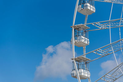 Low angle view of electricity pylon against blue sky