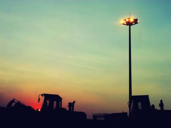 Low angle view of street light against sky at sunset