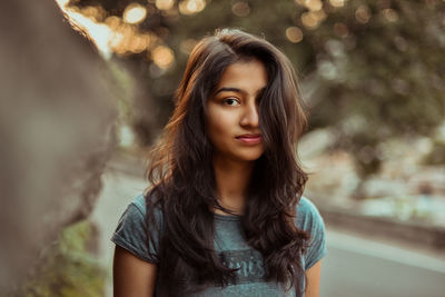 Portrait of beautiful young woman standing outdoors