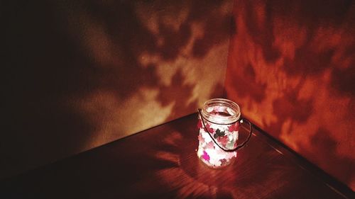 High angle view of illuminated glass light on table