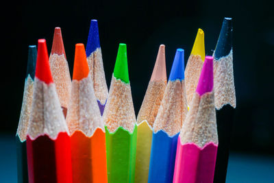 Close-up of colorful flags against black background