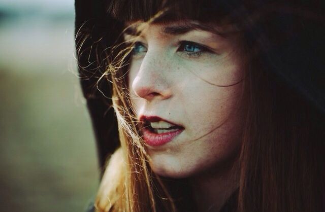 young adult, portrait, person, looking at camera, headshot, young women, front view, lifestyles, long hair, close-up, focus on foreground, leisure activity, smiling, human face, head and shoulders, serious