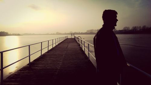 Pier on sea at sunset