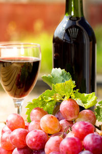 Close-up of grapes with wine on table