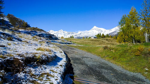 Scenic view of mountains against clear blue sky