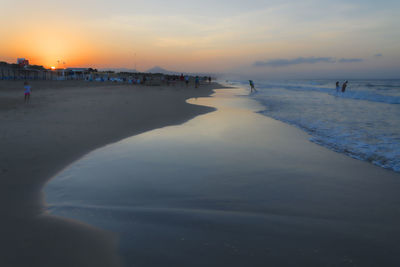 Scenic view of beach against sky during sunset