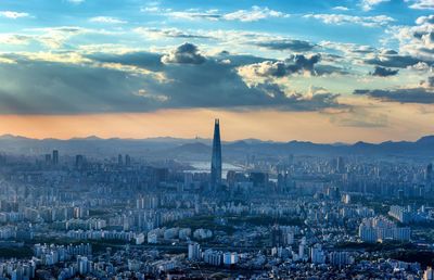 Aerial view of city against sky during sunset