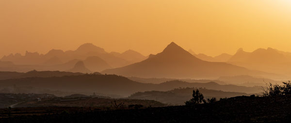 Scenic view of mountains against sky during sunset