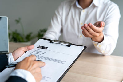 Midsection of man using mobile phone