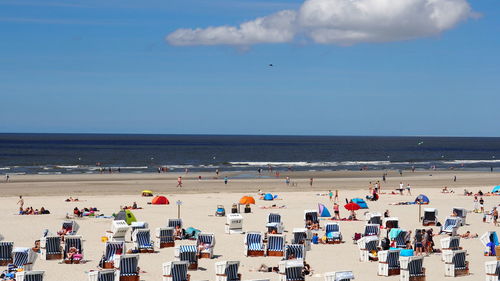 People on beach against sky